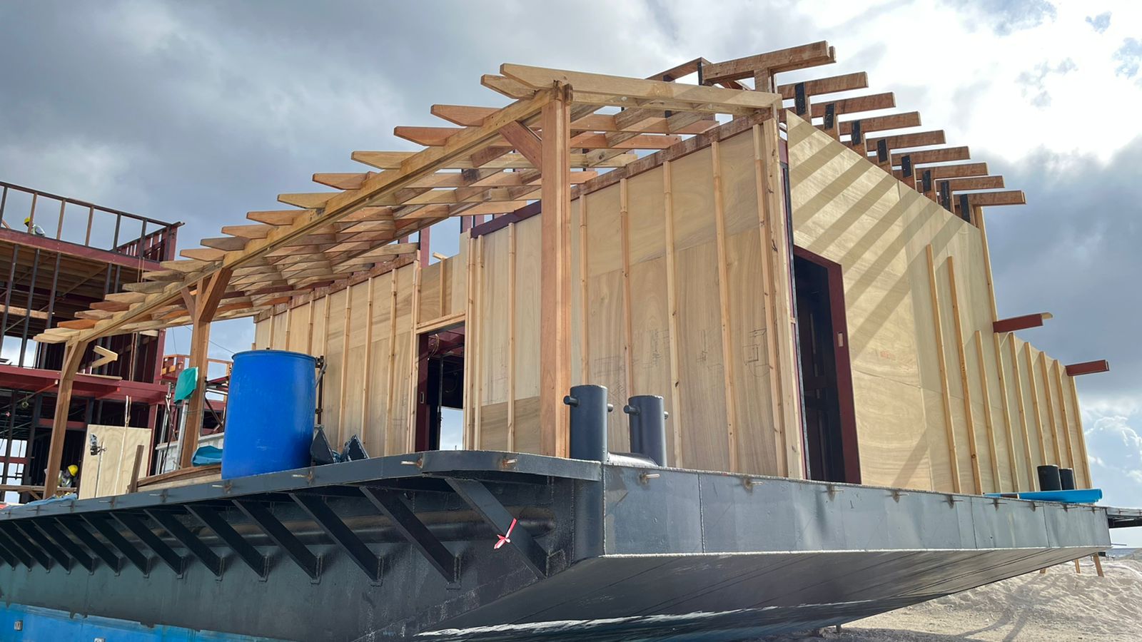 Steel Solution v1.0 modular hull with a timber Water Suite structure under construction in the Maldives